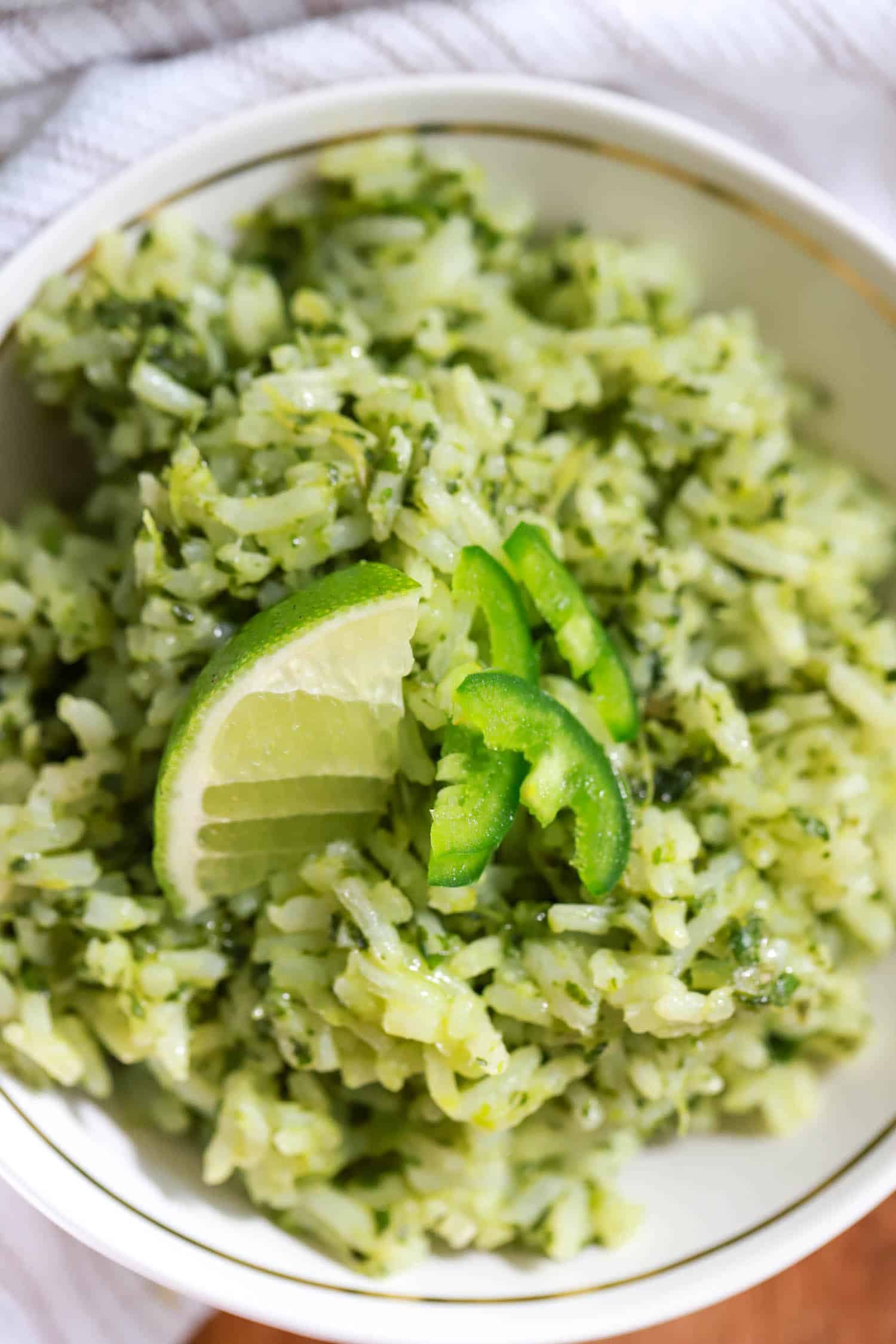 Close up top view of Mexican green rice with cilantro and lime.