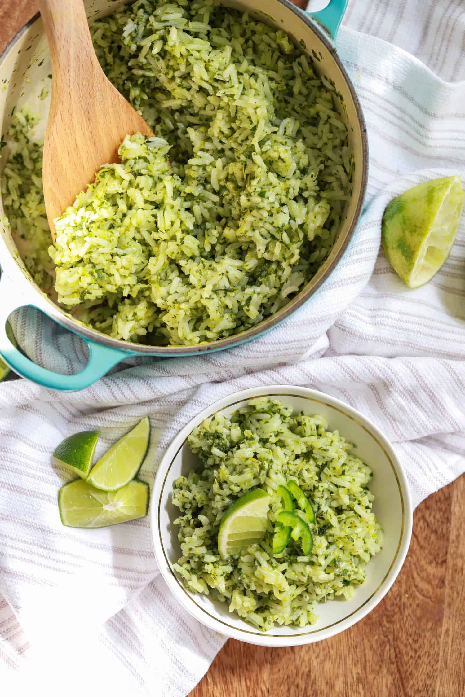 Small white bowl near a larger pot of green cilantro lime rice.