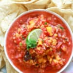 peach jalapeno salsa with pale white chips.