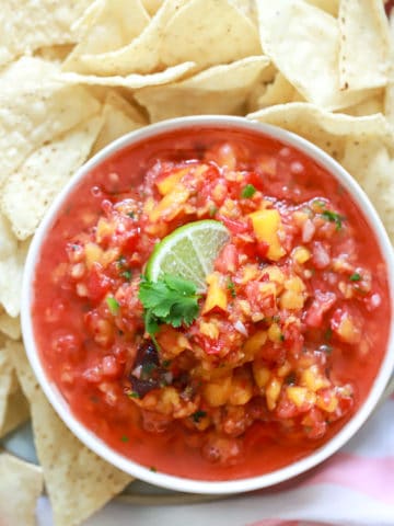 peach jalapeno salsa with pale white chips.