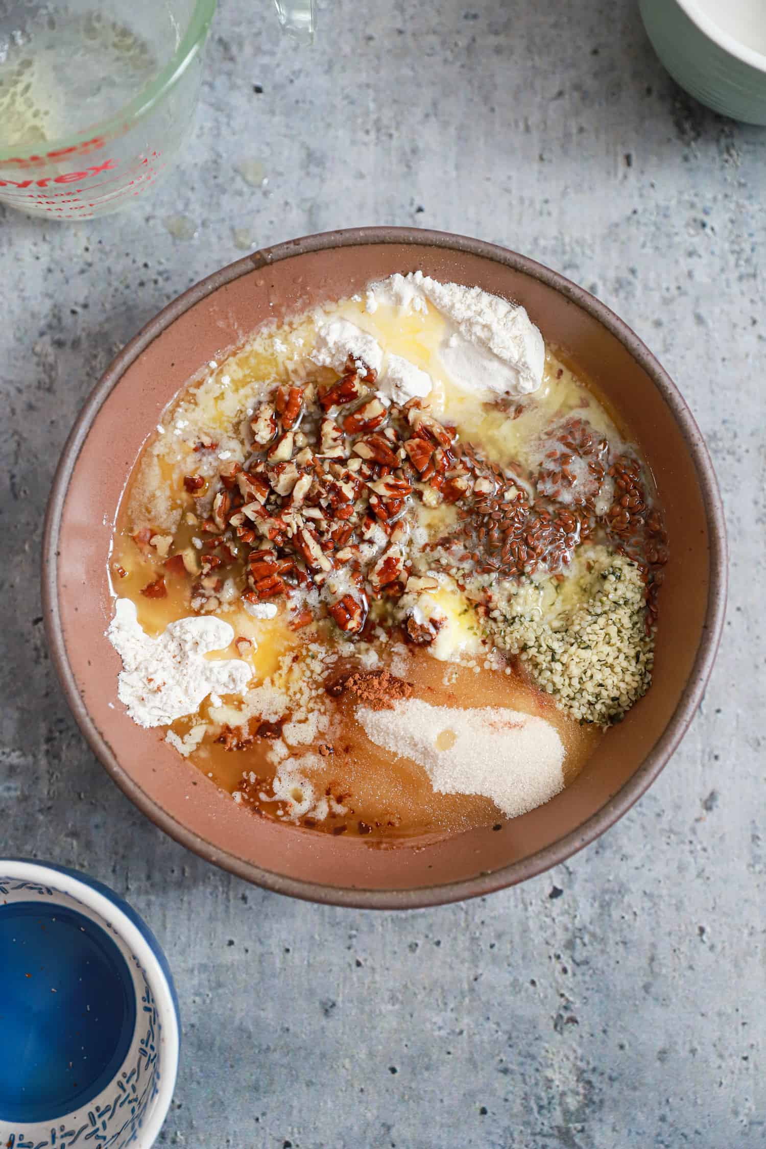 dusty pink bowl with ingredients for apple crumble strudel topping.