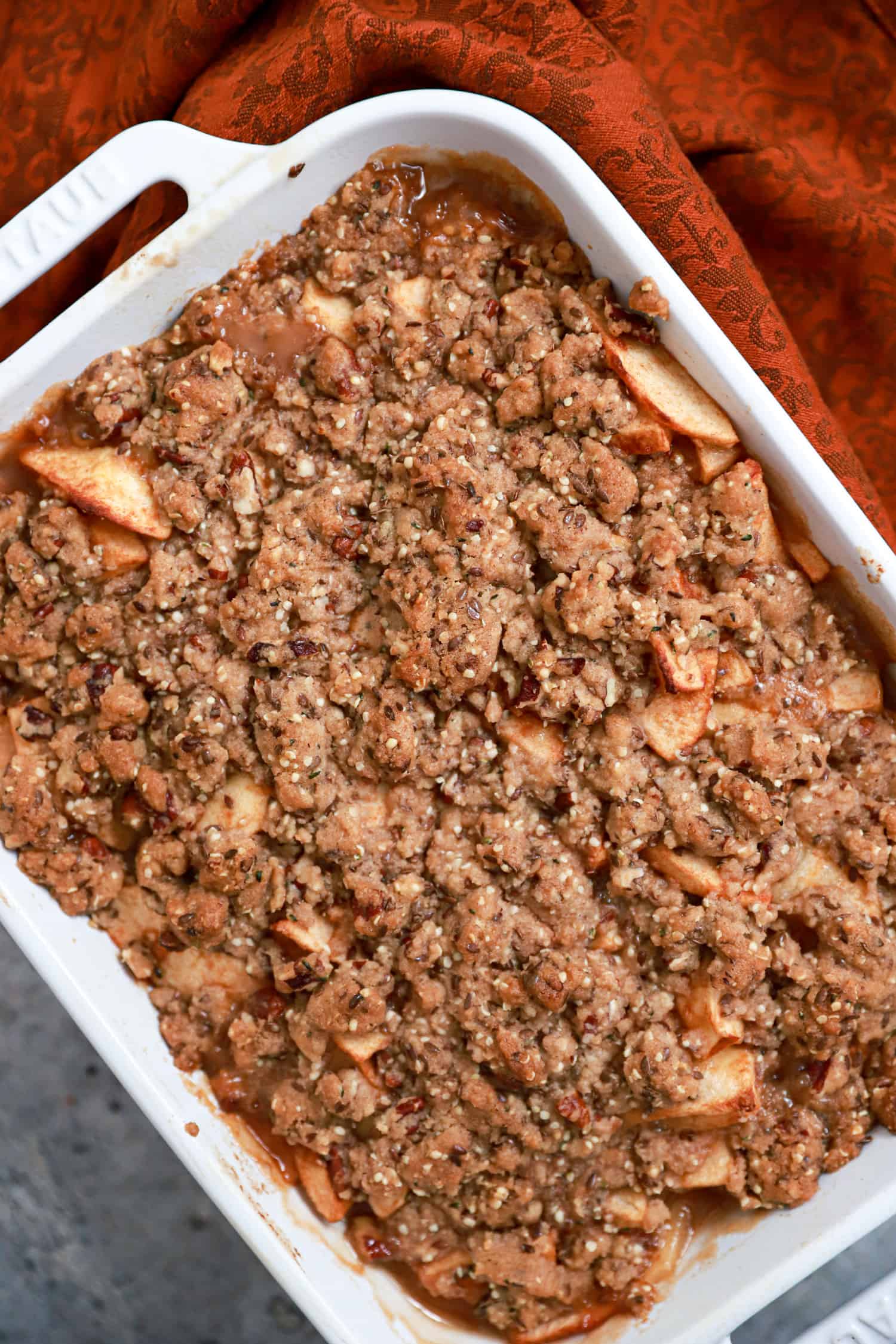 apple crisp without oatmeal baked in white baking dish.