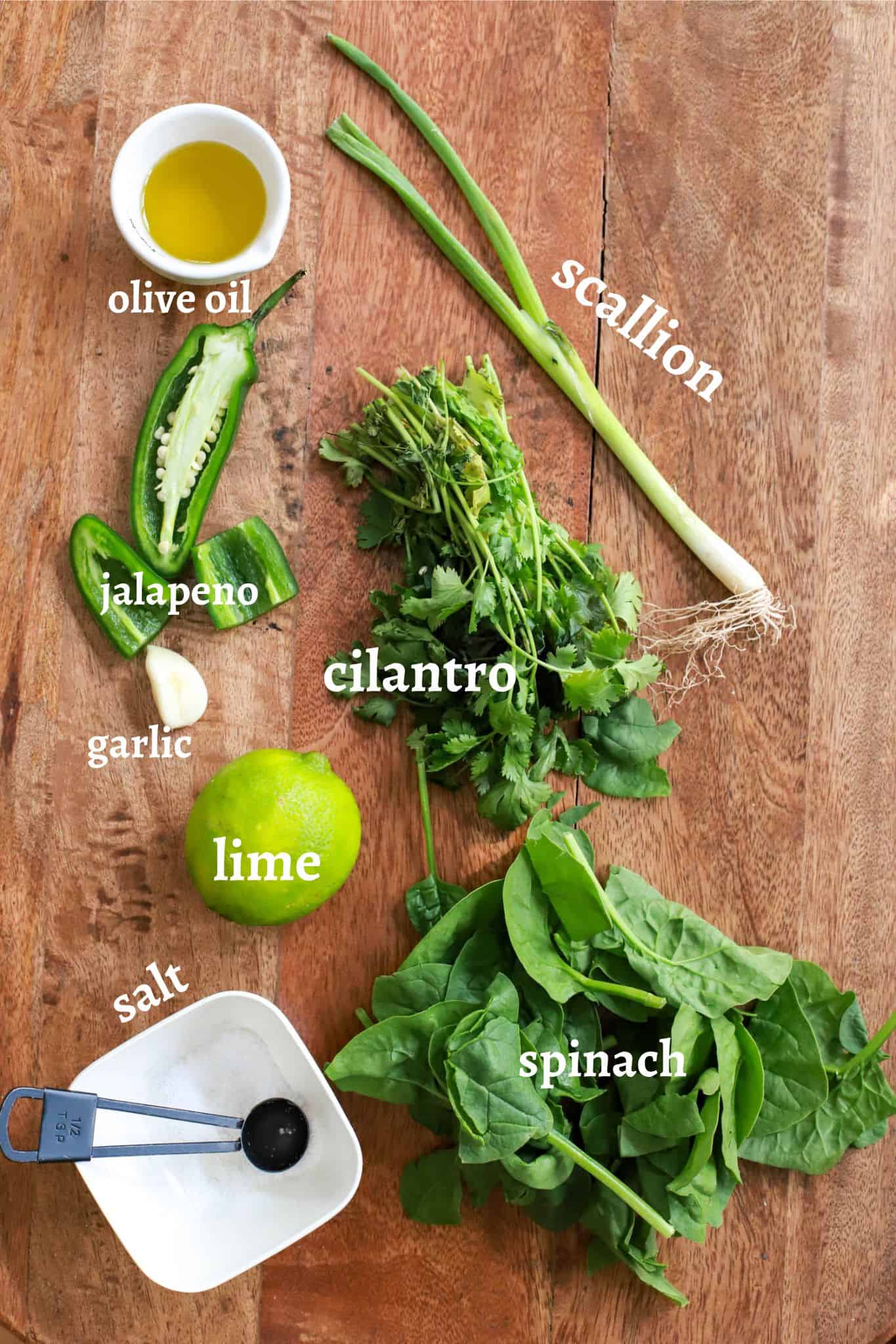 Ingredients for cilantro lime rice on wooden board with labeled text.