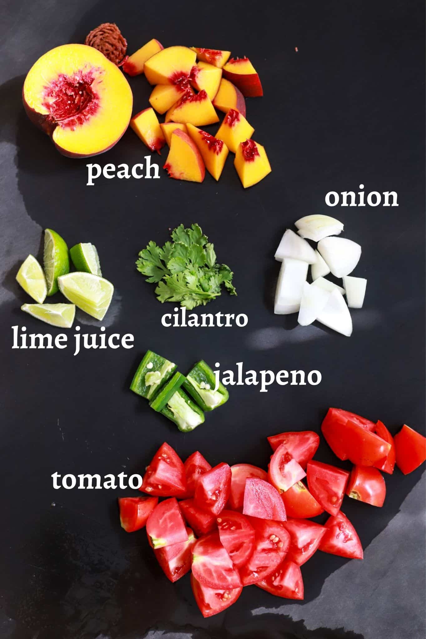 black board with labeled ingredients for peach salsa.