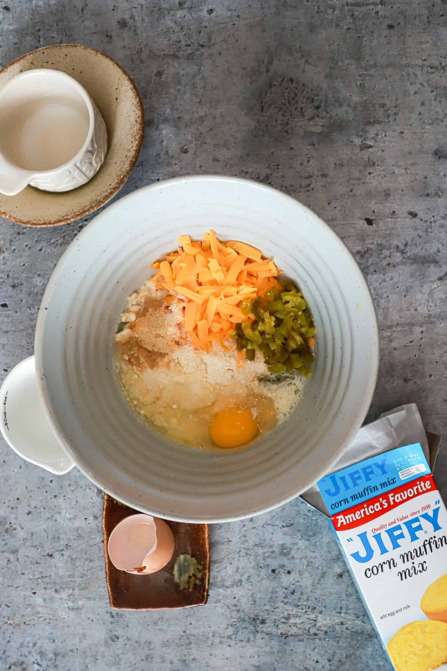 ceramic bowl with ingredients for jalapeno corn muffins unmixed.