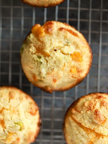 close up jalapeno corn muffin on wire rack.