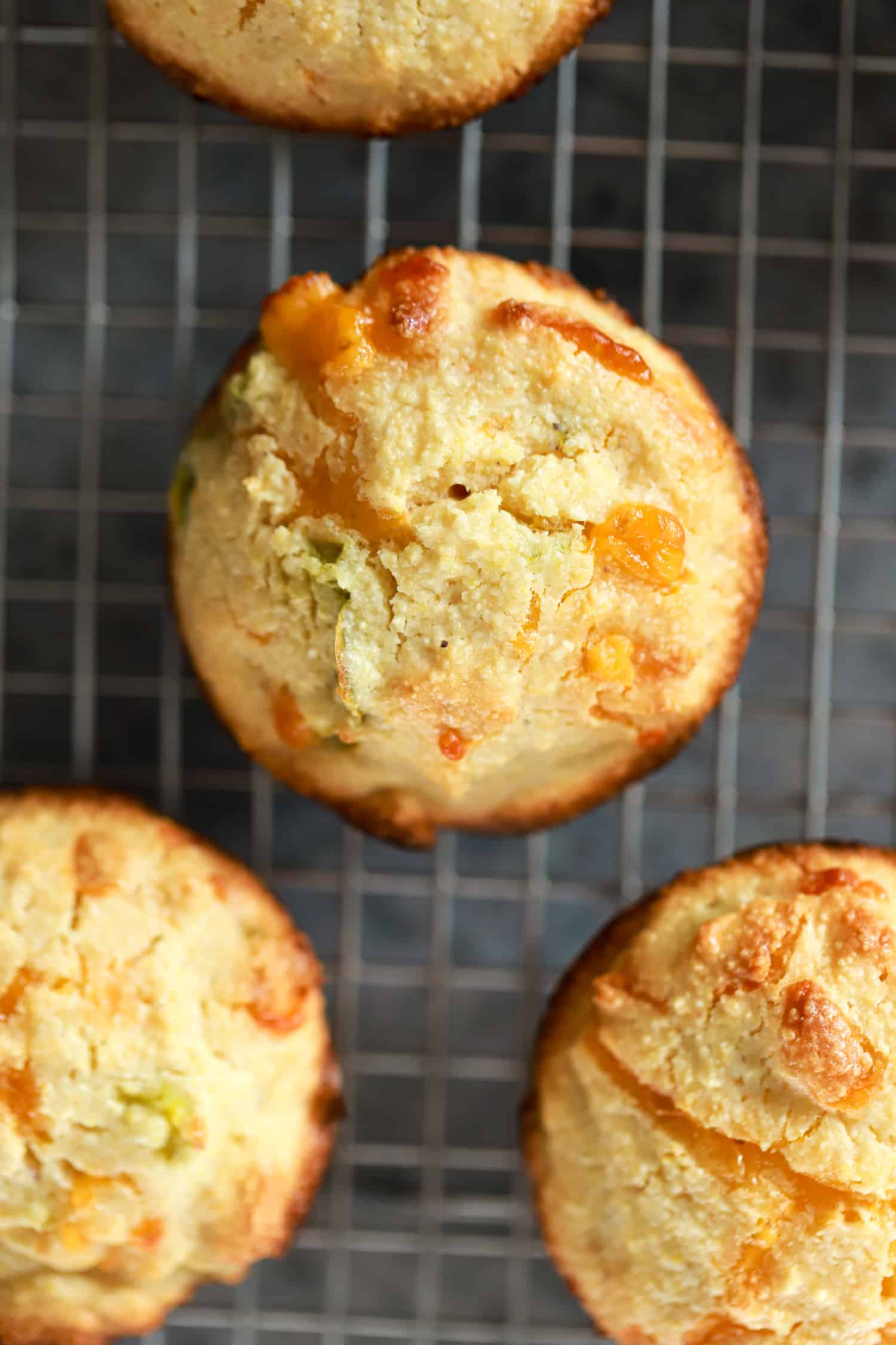 close up jalapeno corn muffin on wire rack.