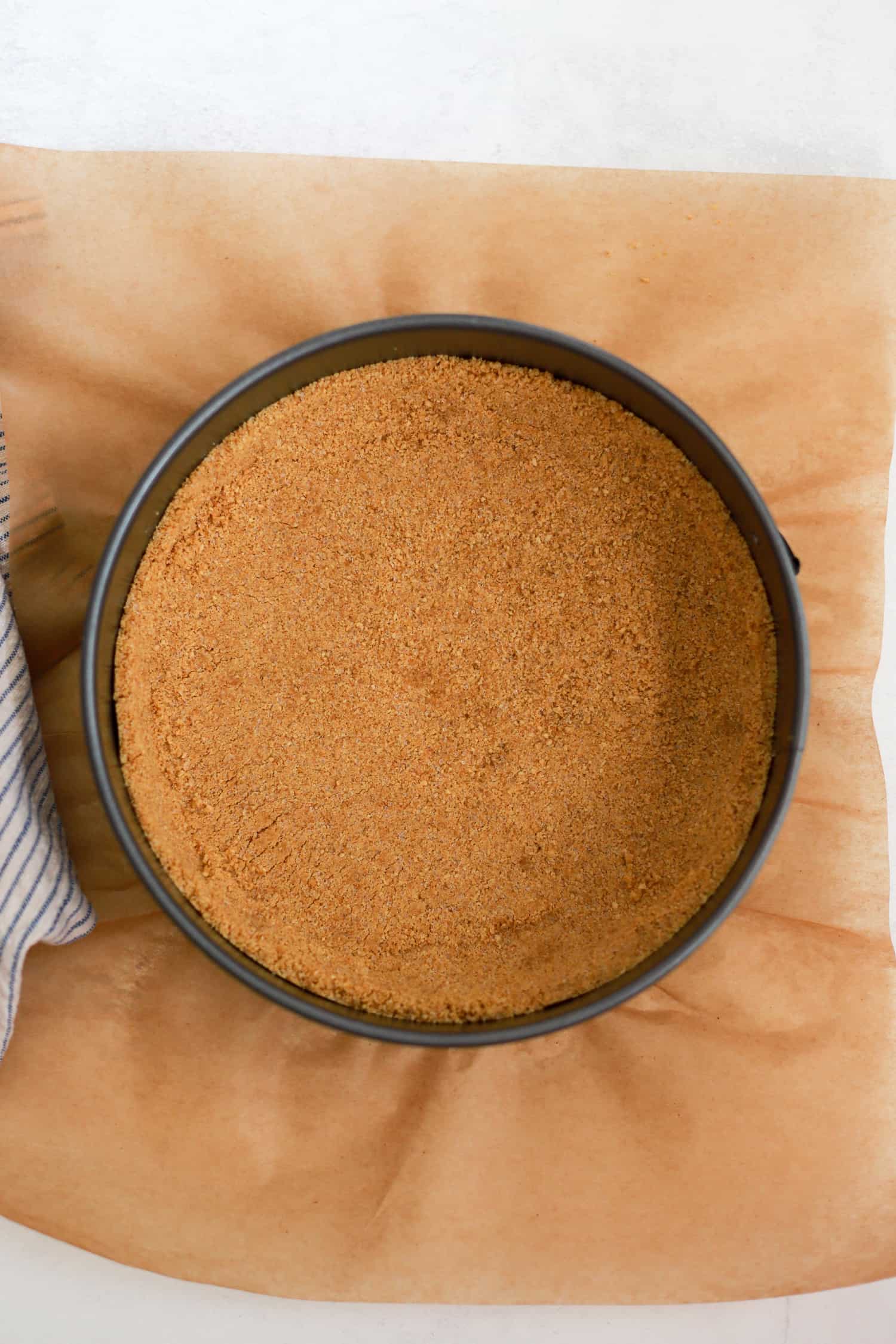 Graham cracker crust pressed into the bottom of a springform pan.