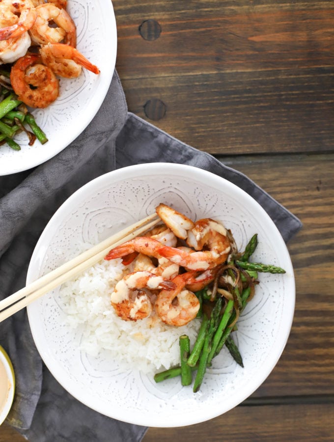 homemade hibachi shrimp bowl in white serving bowl with asparagus and white rice.
