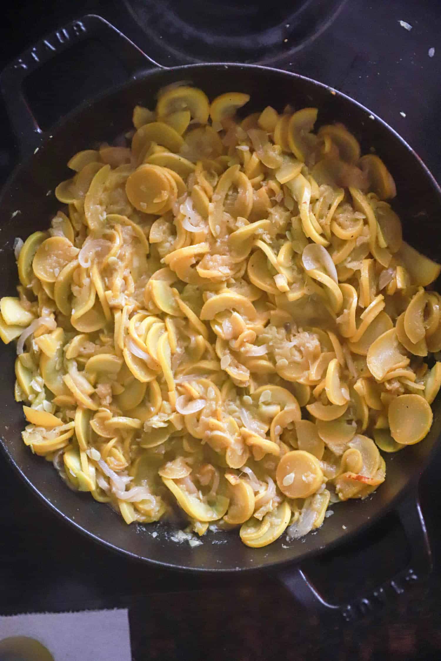 Sauteed squash and onions in large black skillet.