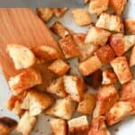 white skillet of croutons with gray title.