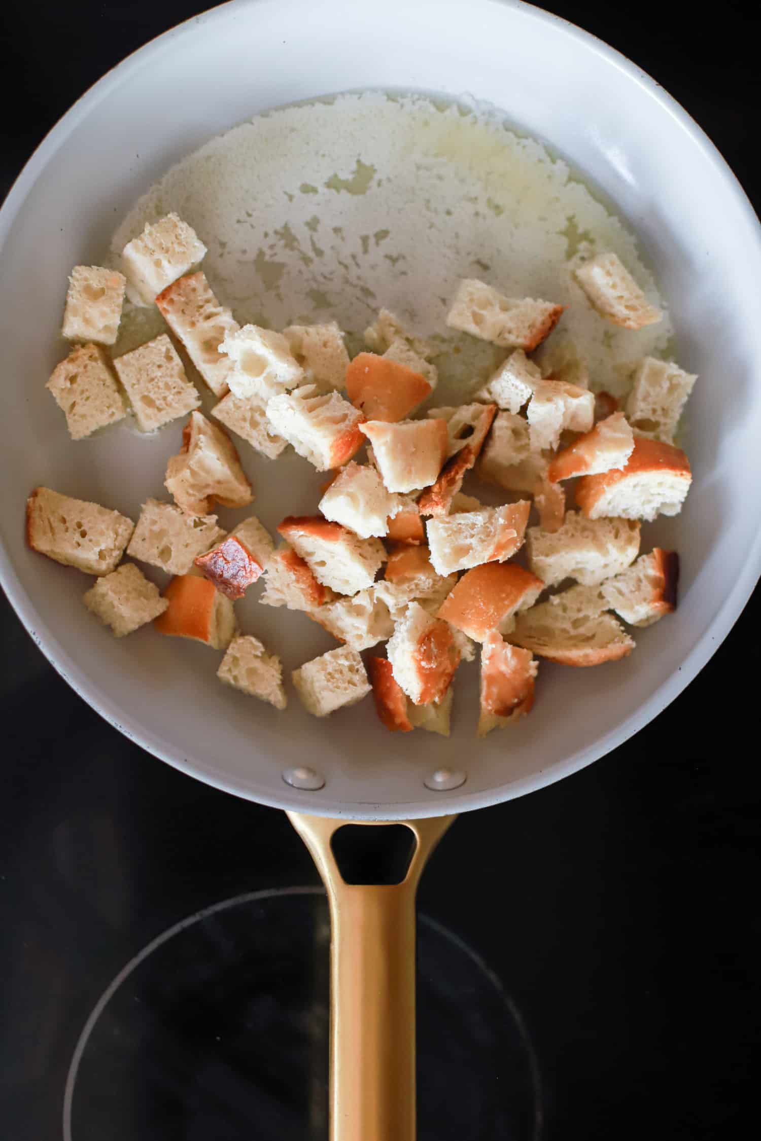 ceramic nonstick skillet with bread cubes for croutons.