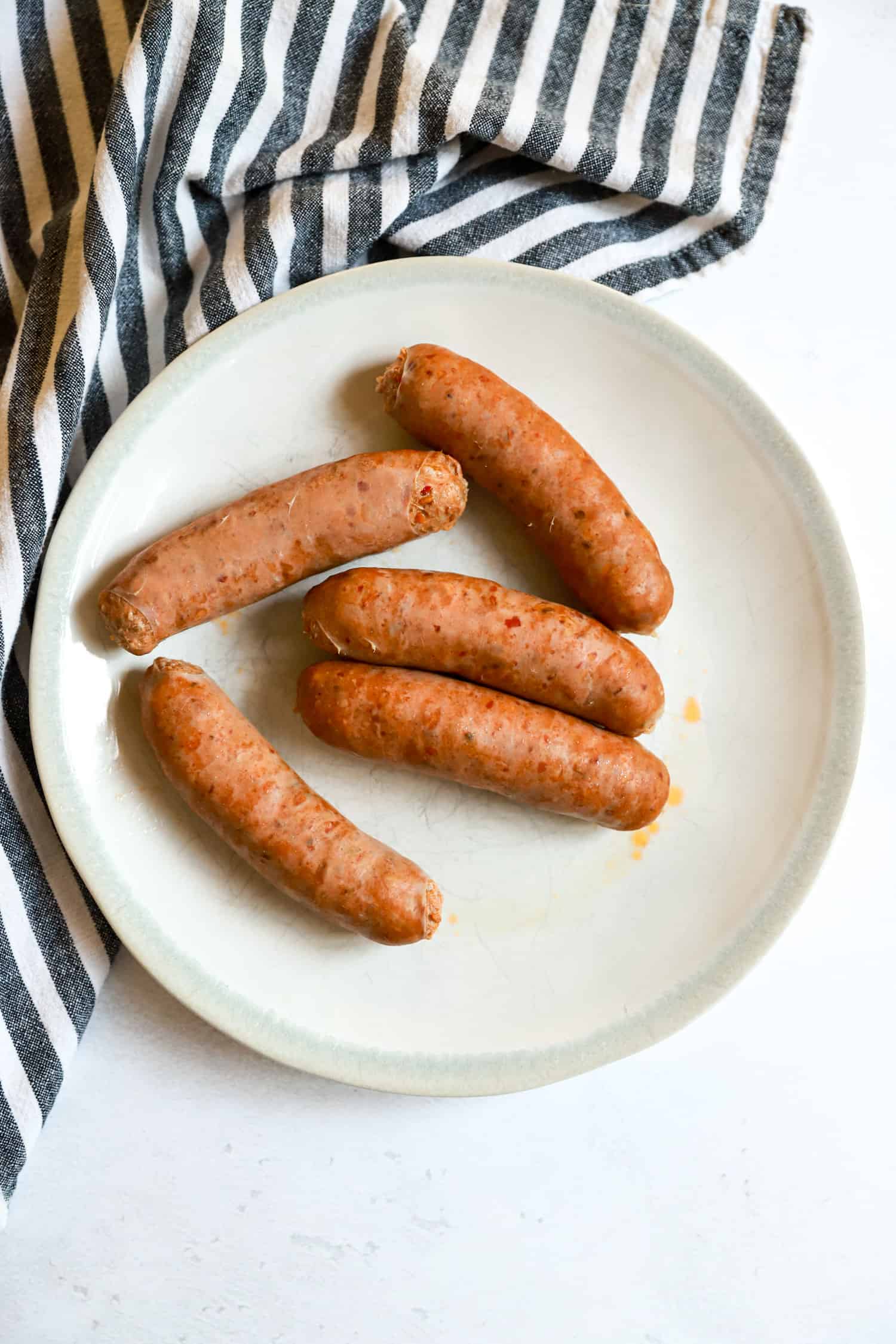 white plate with boiled sausage links