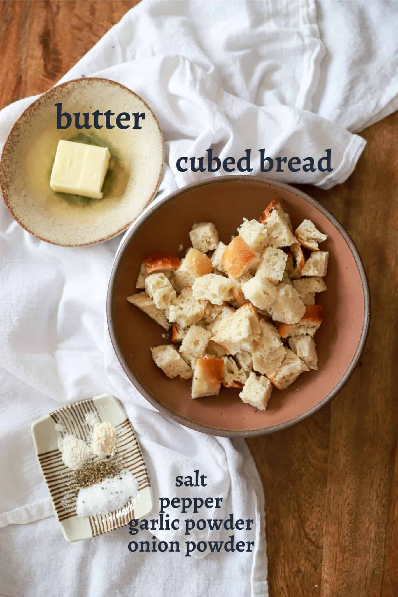 labeled ingredients for homemade croutons with white cloth.