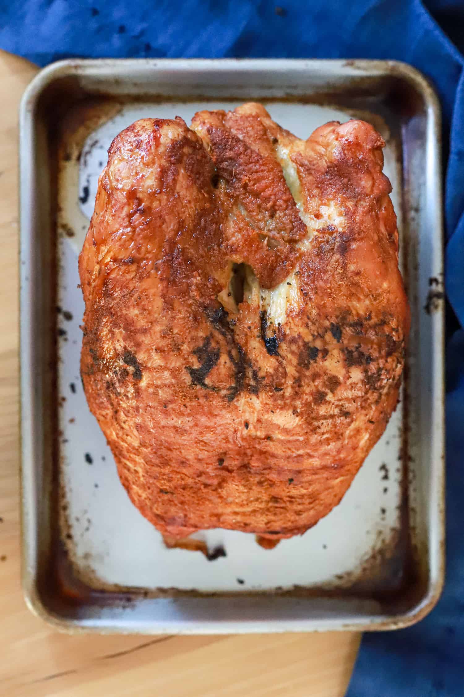whole smoked turkey breast on baking sheet.