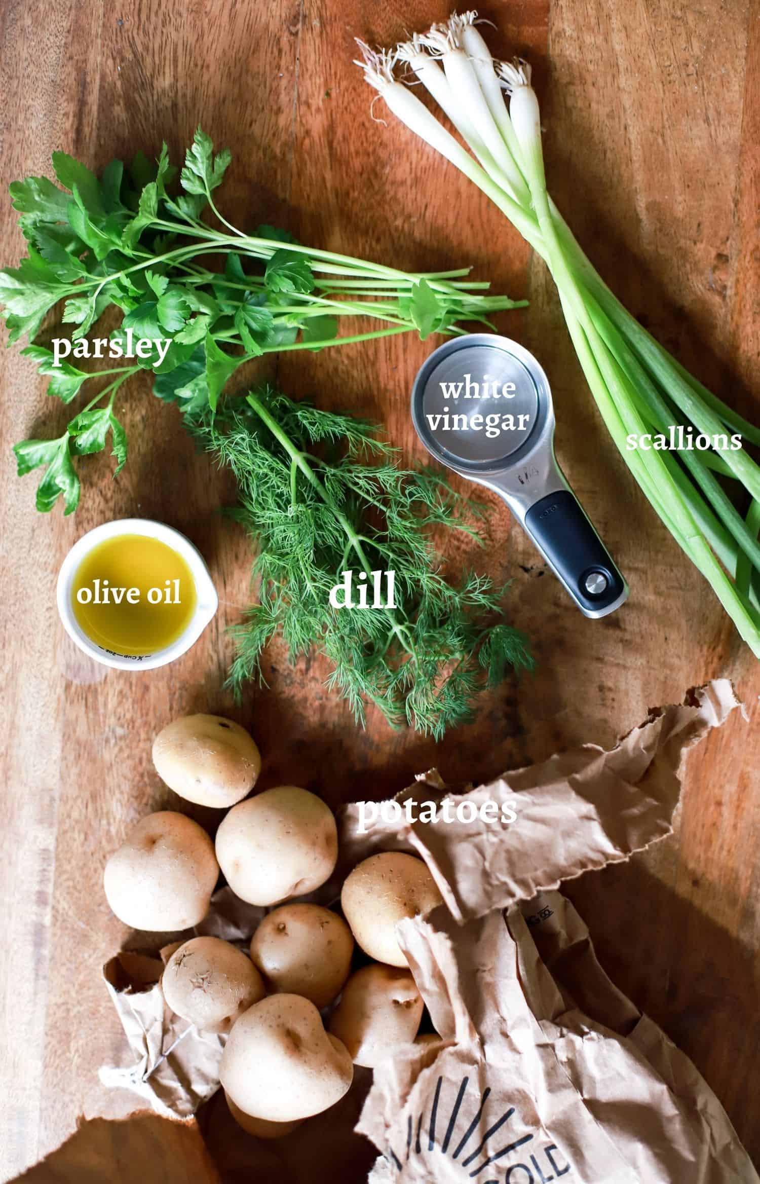 vegan potato salad ingredients on black cutting board