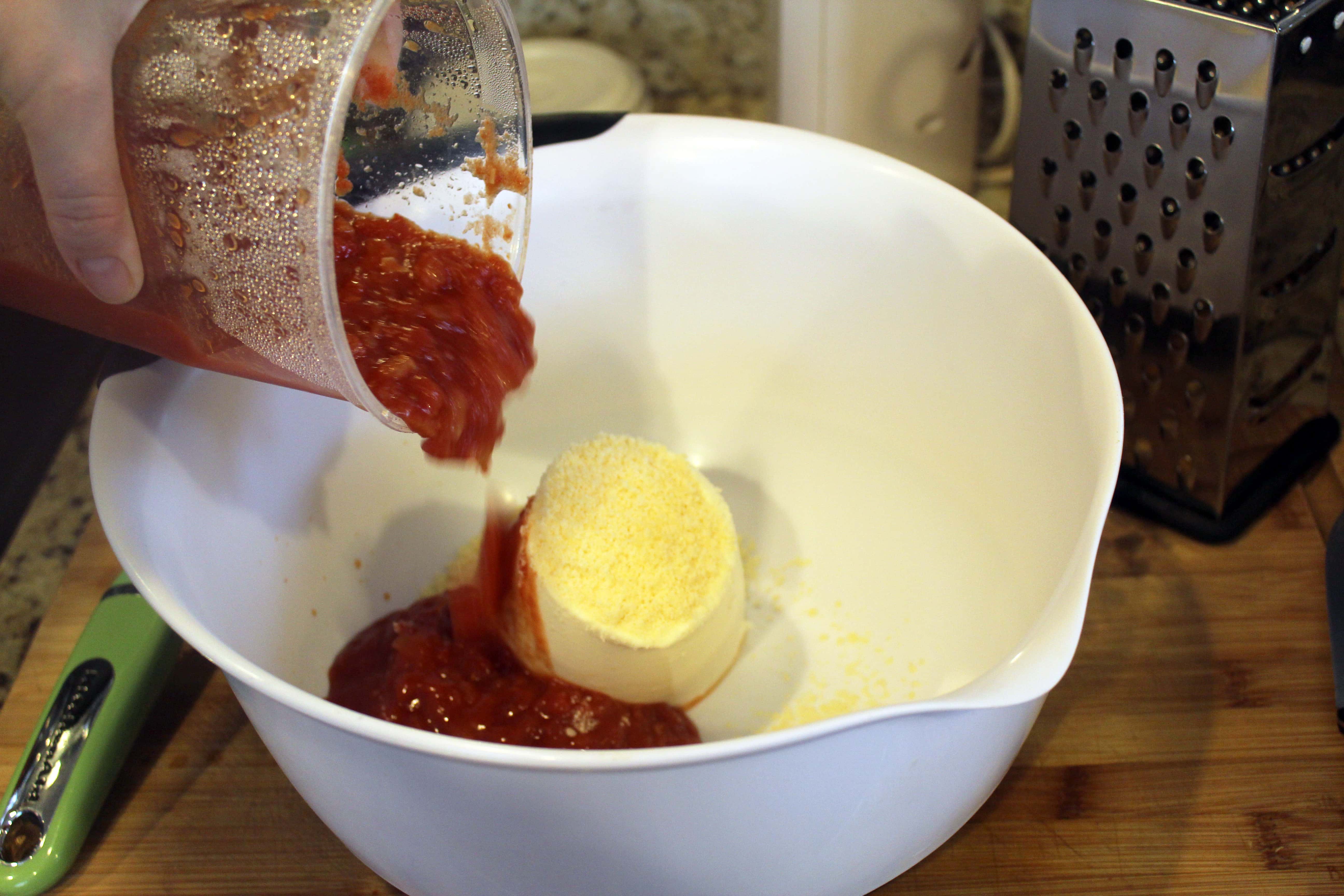 Add sauce and cheese to ricotta