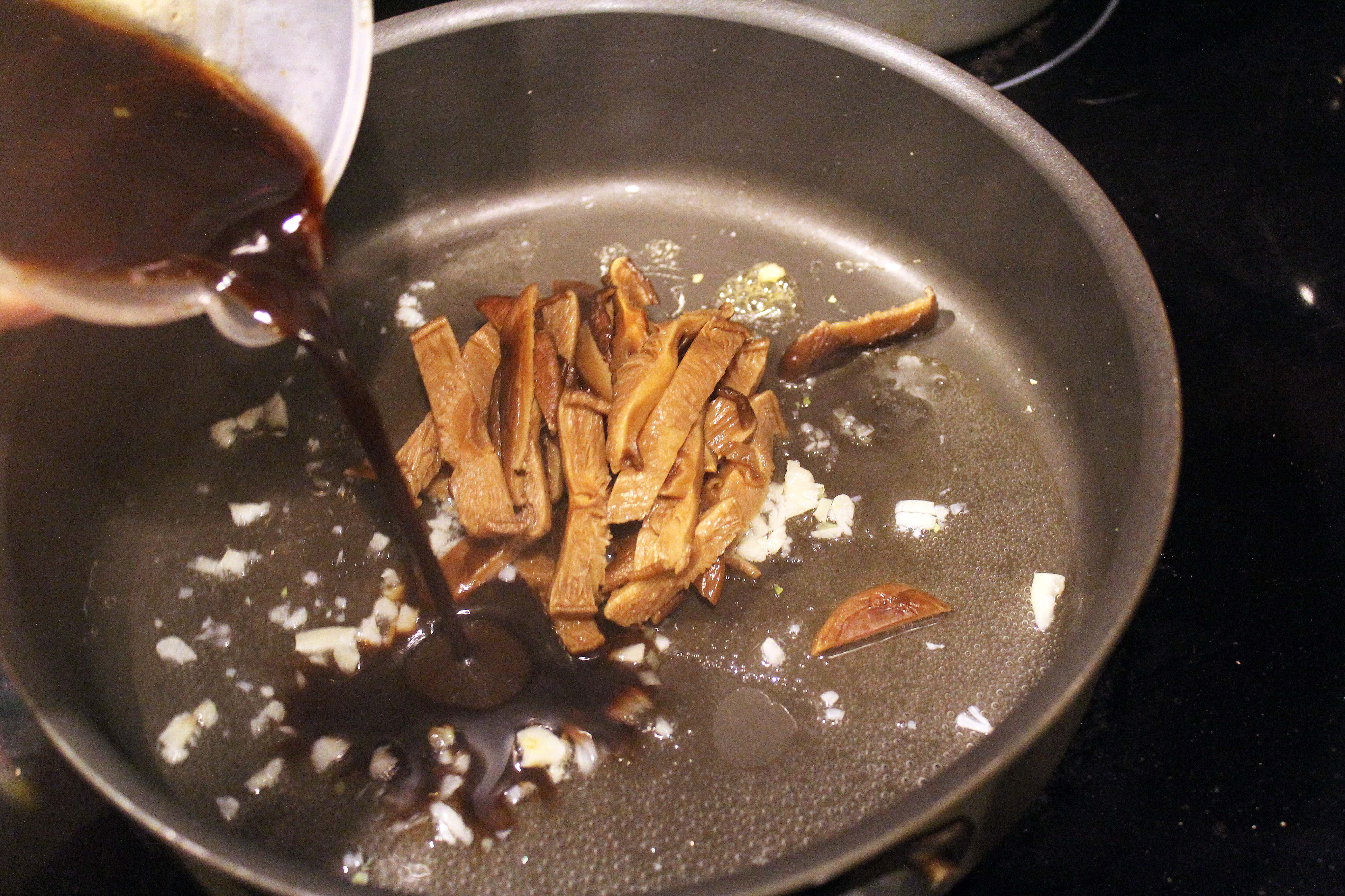 Add sauce and shiitake to garlic and water