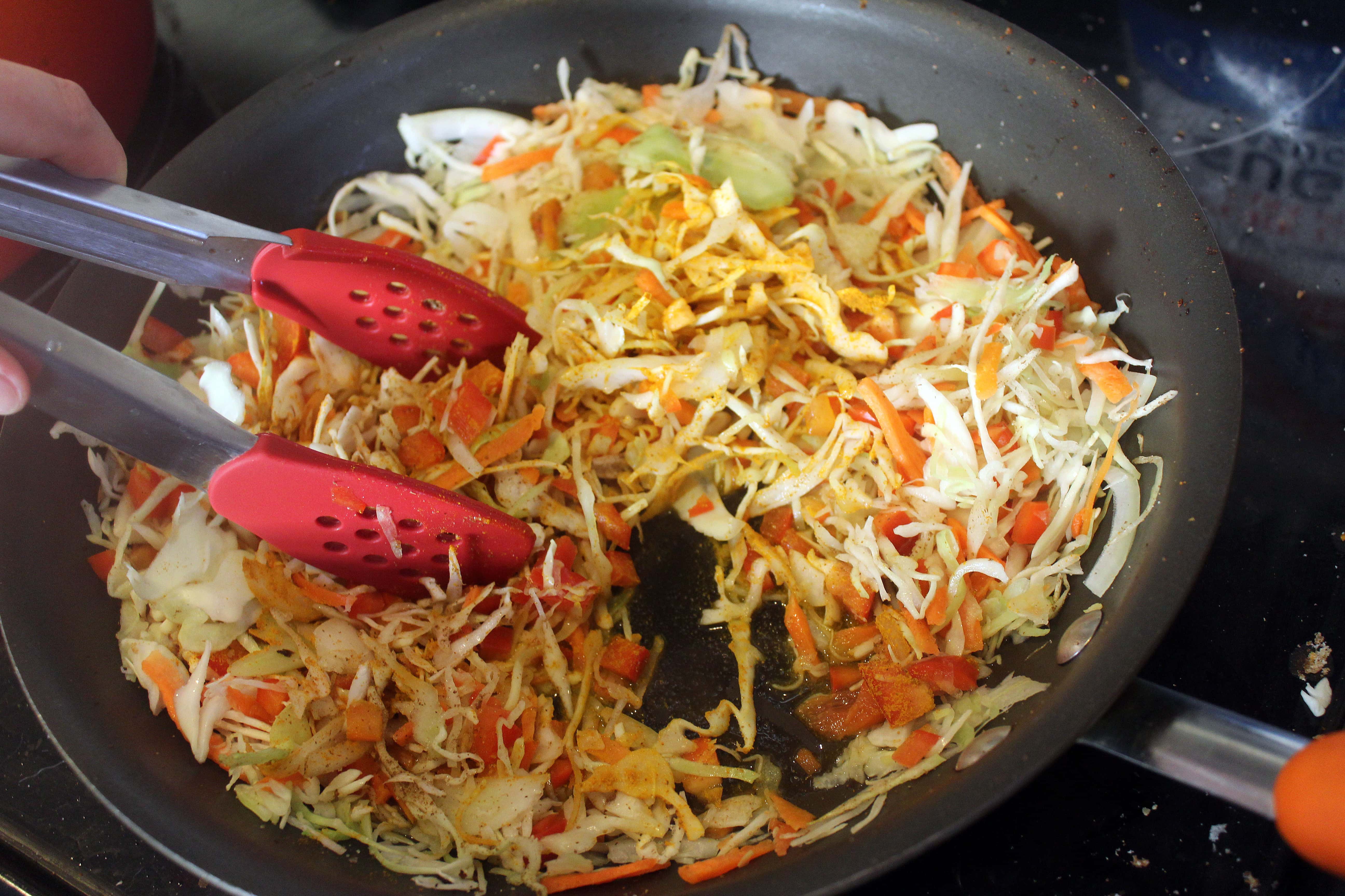 Use tongs to incorporate spices