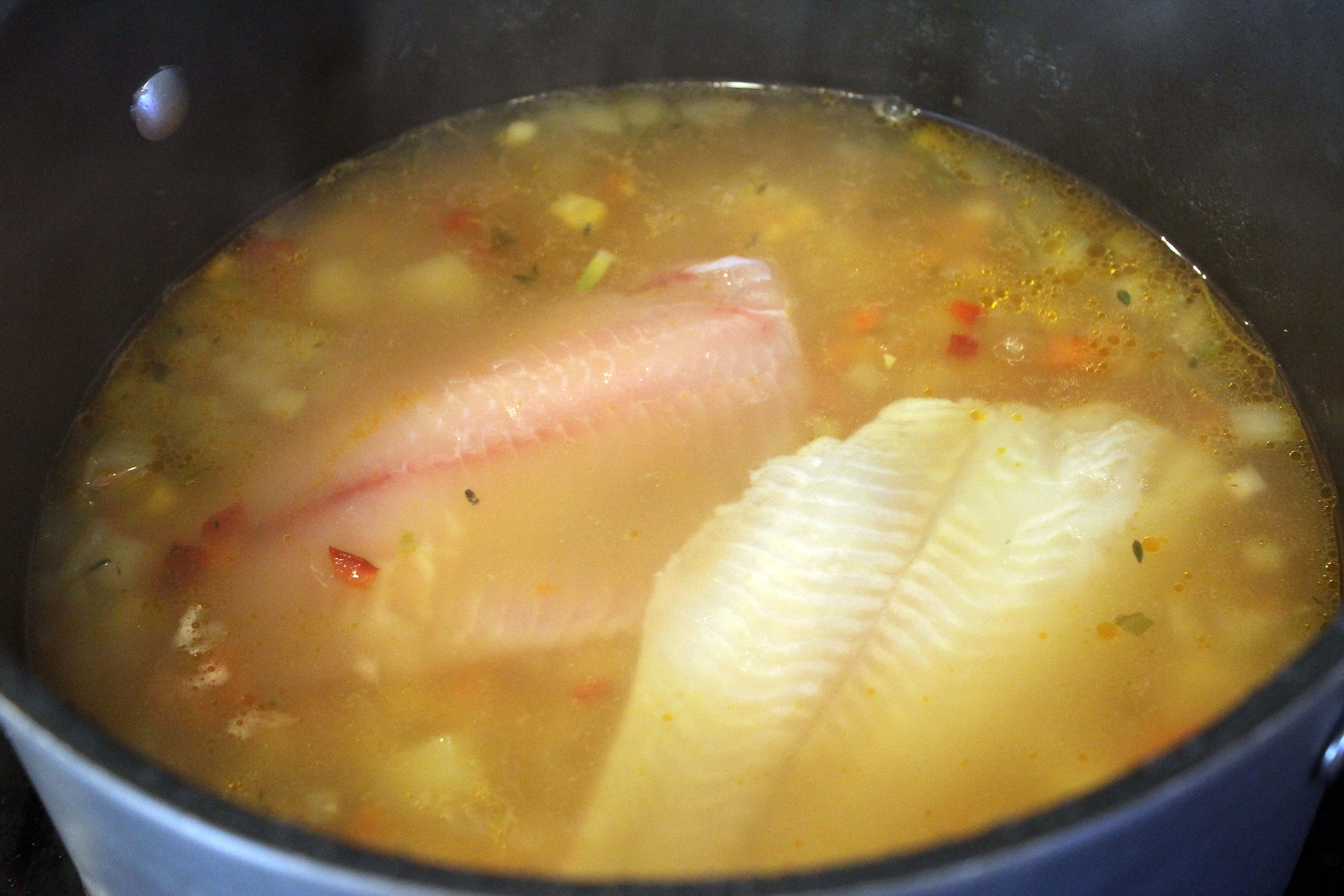 Add fish to cooked soup to let simmer