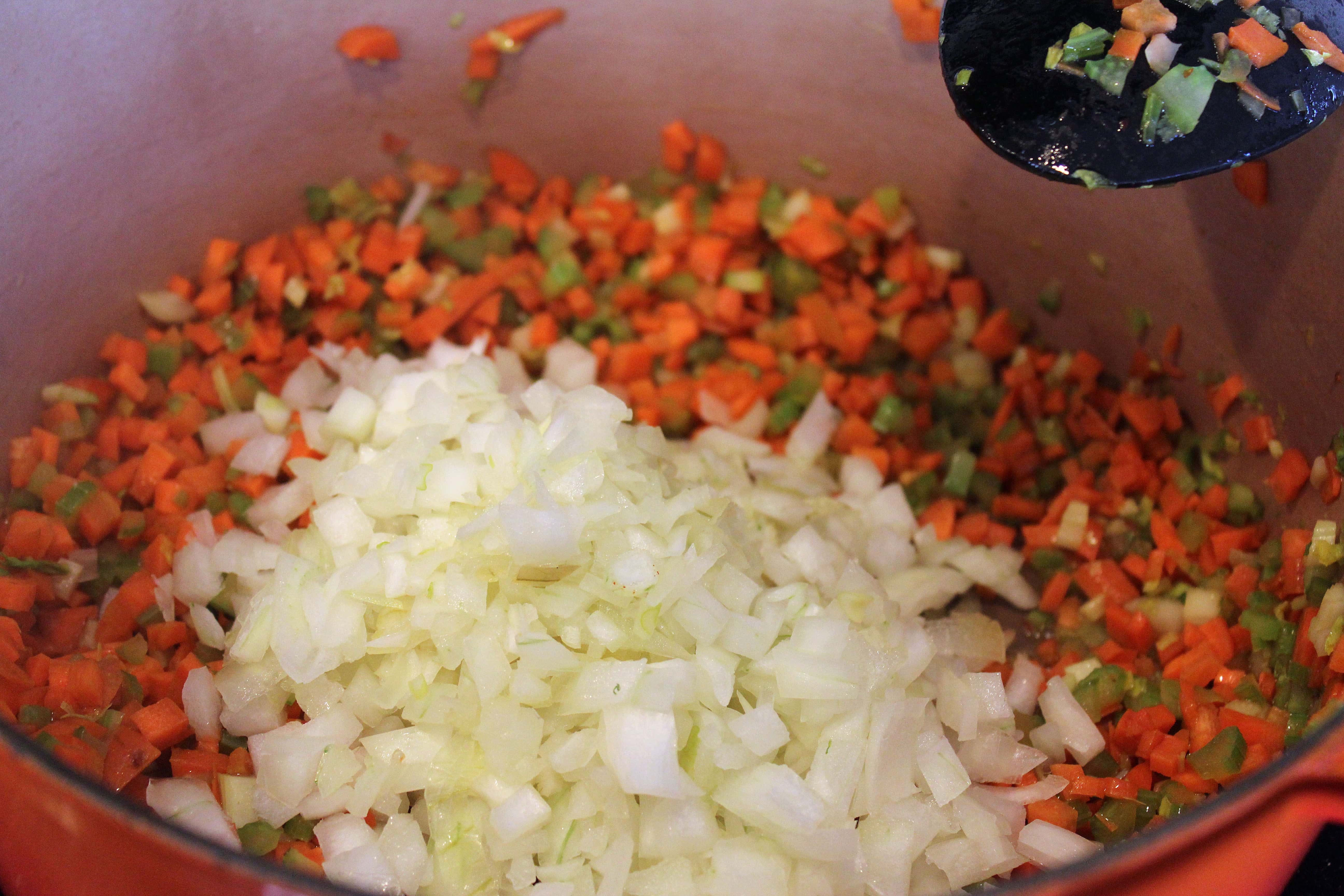 Add onion to softened hard veggies