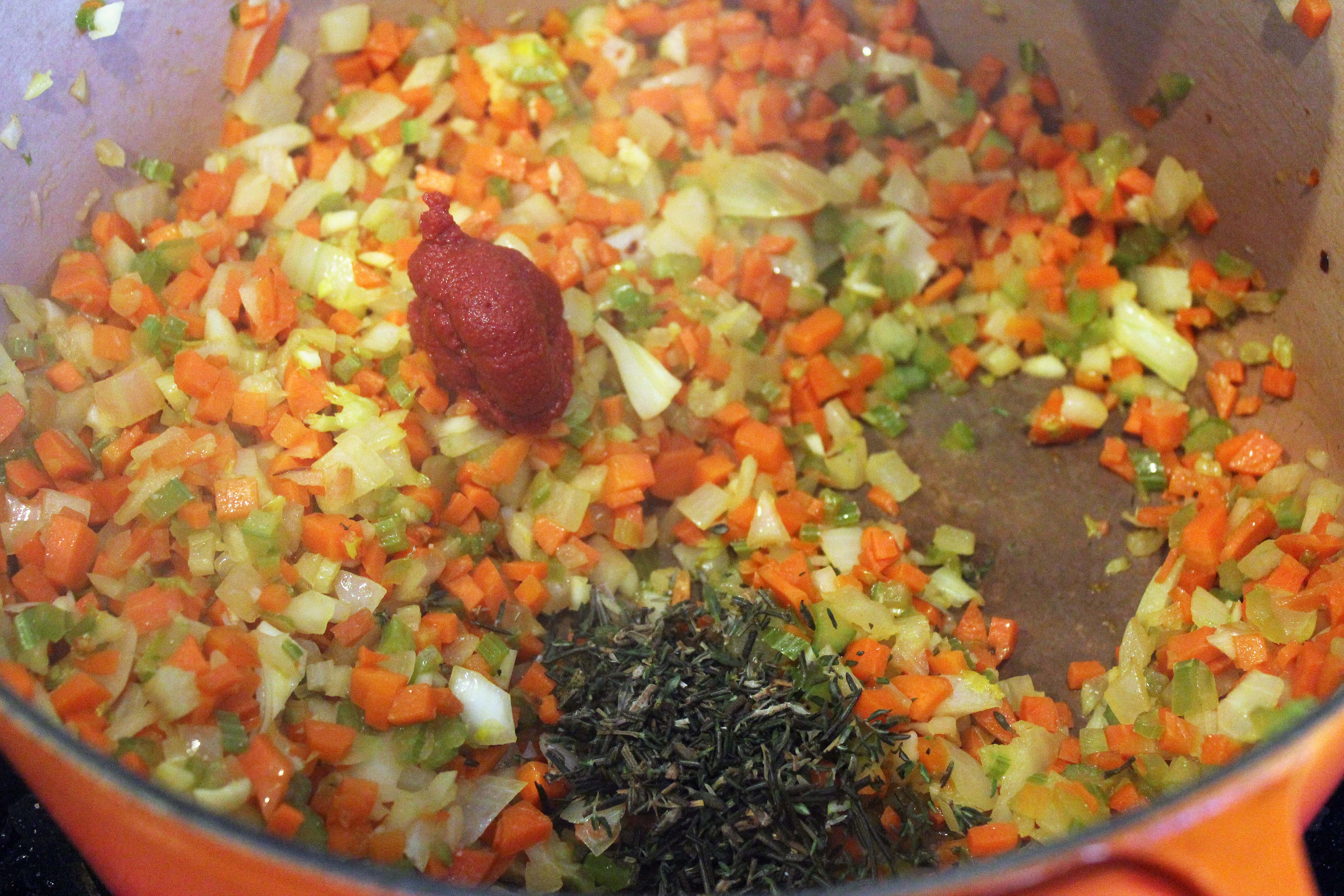 Add tomato paste and herbs to chopped veggies