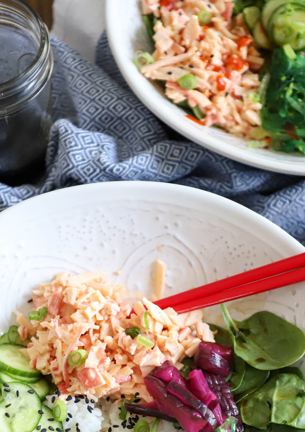 crab salad sushi bowls with japanese pickles in white bowl.