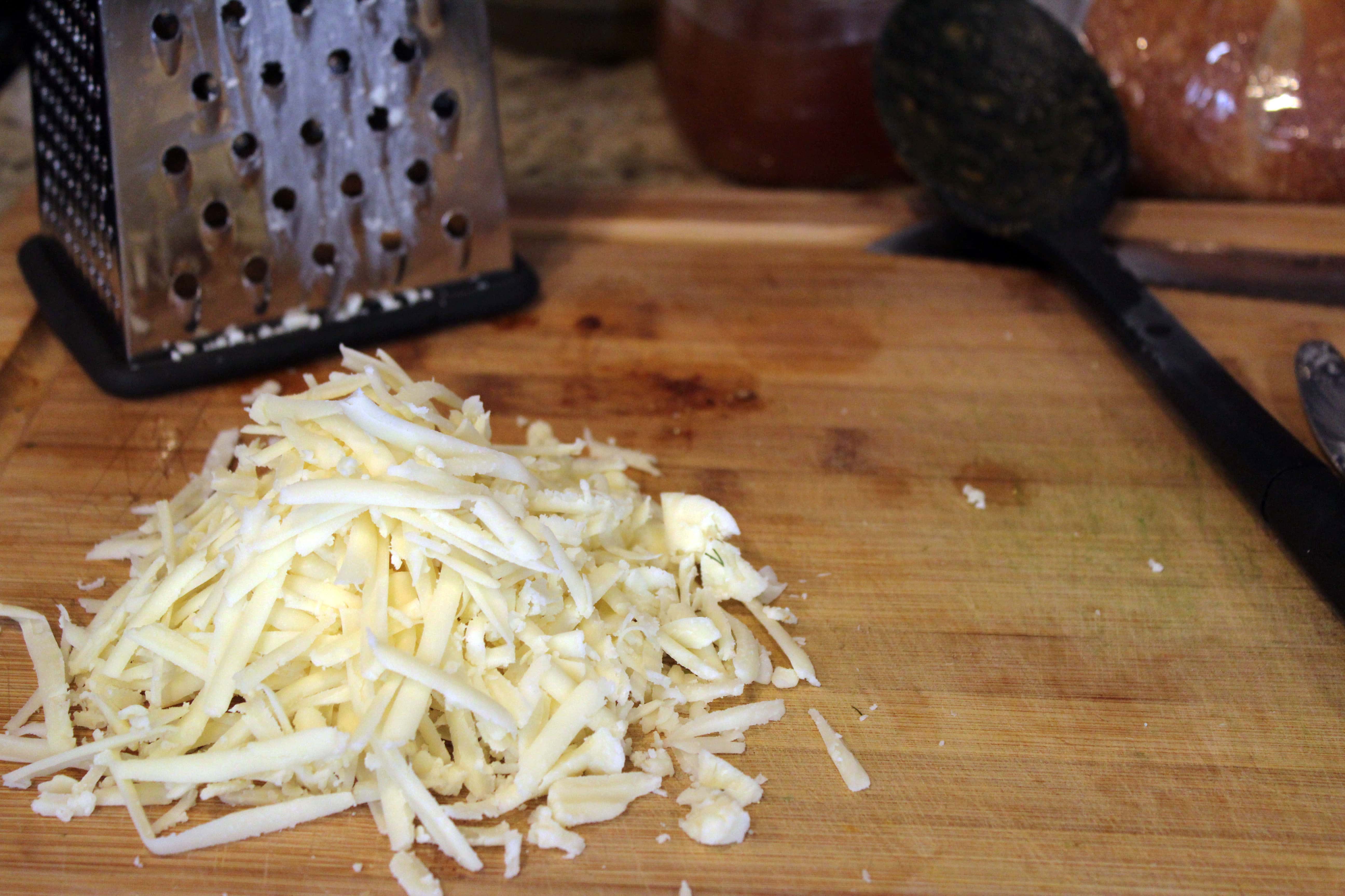 Grate cheese while veggies cook