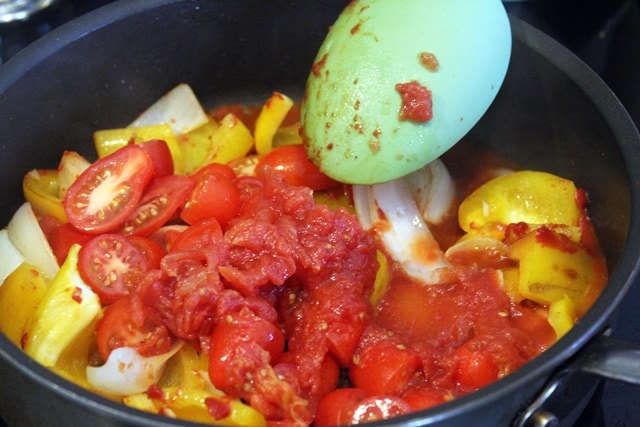 Add canned tomatoes to veggies