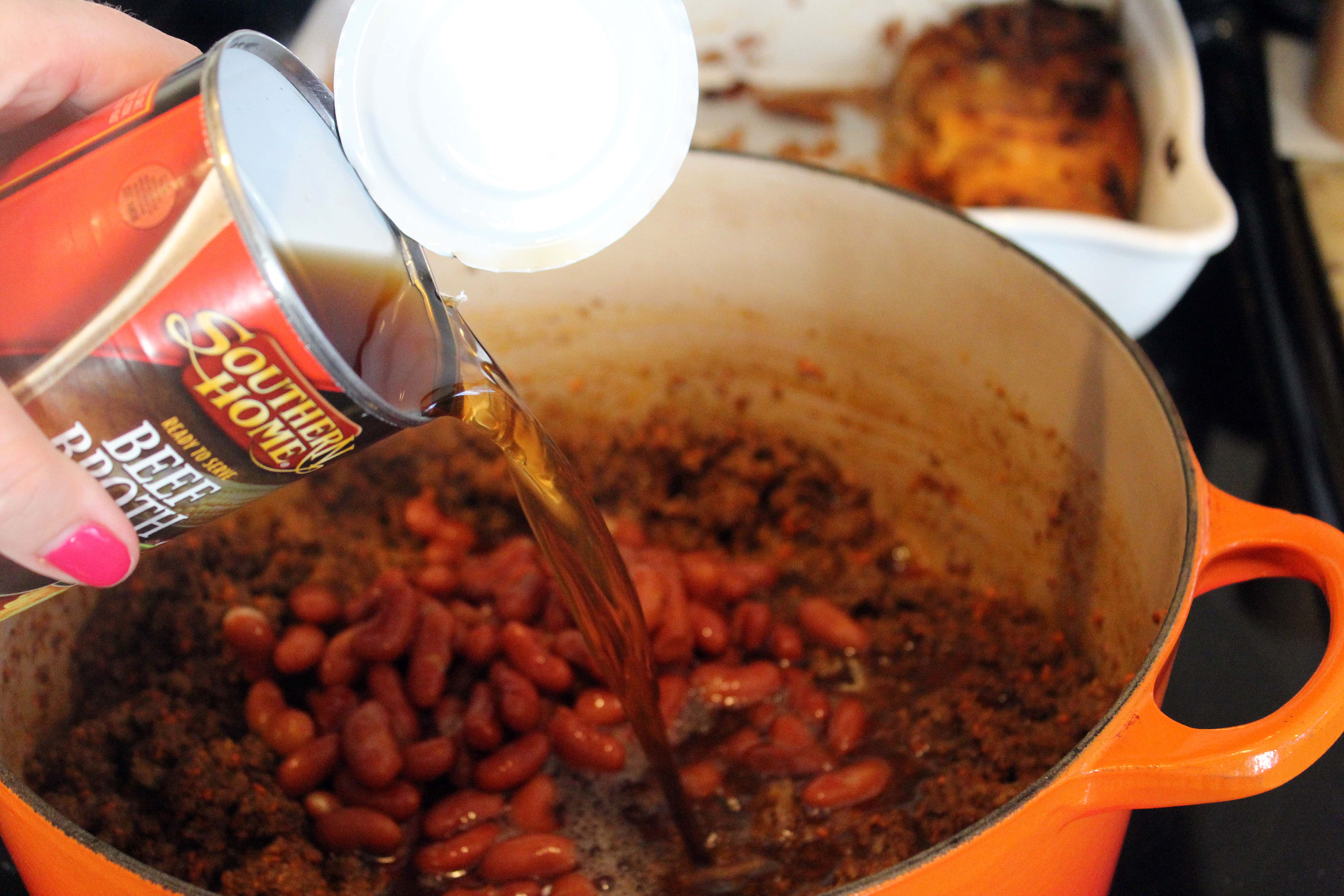 Add beef stock and beans after spices