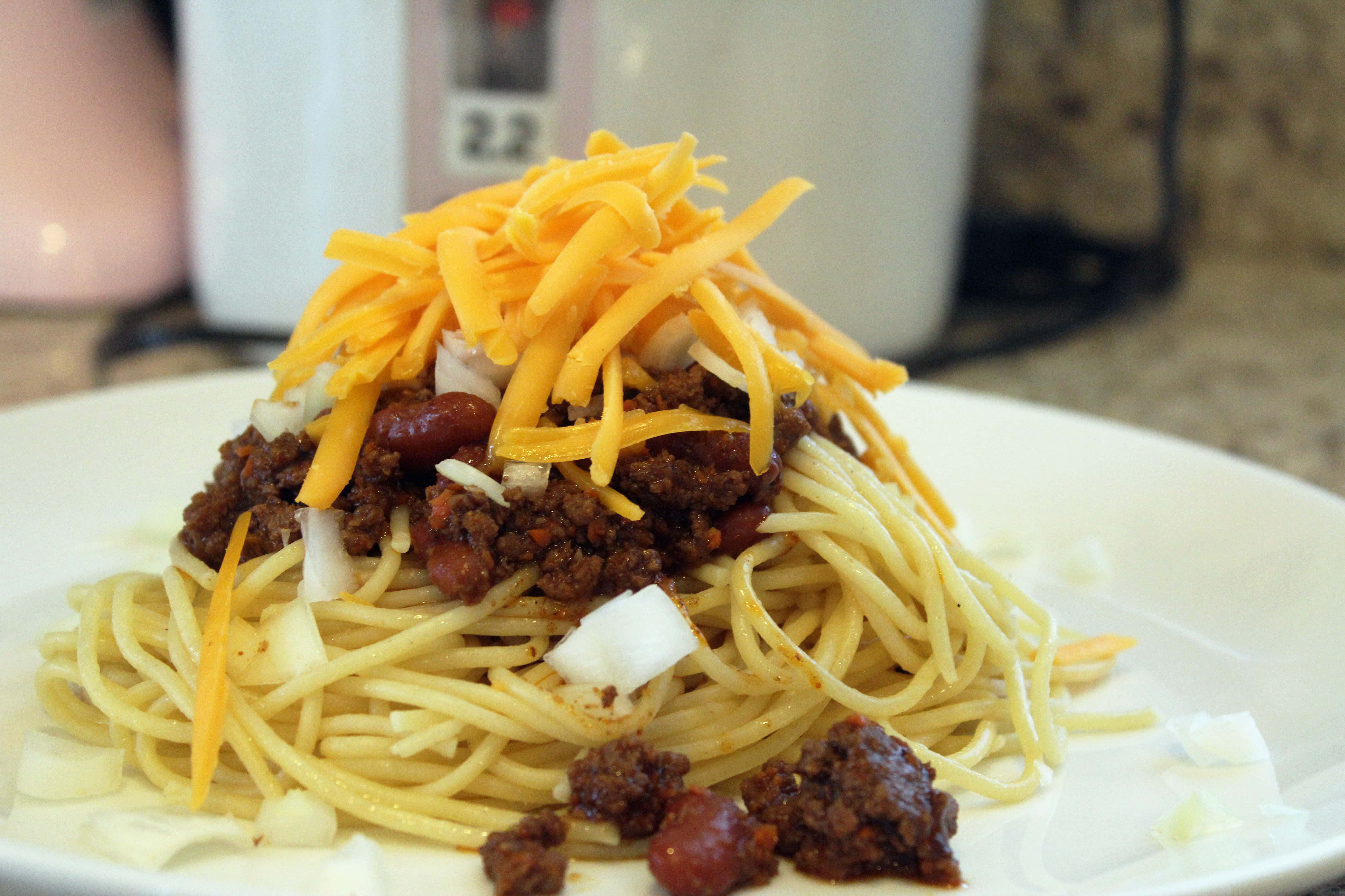 Spaghetti topped with chili and cheese