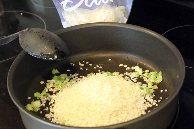 Add rice to softened onions