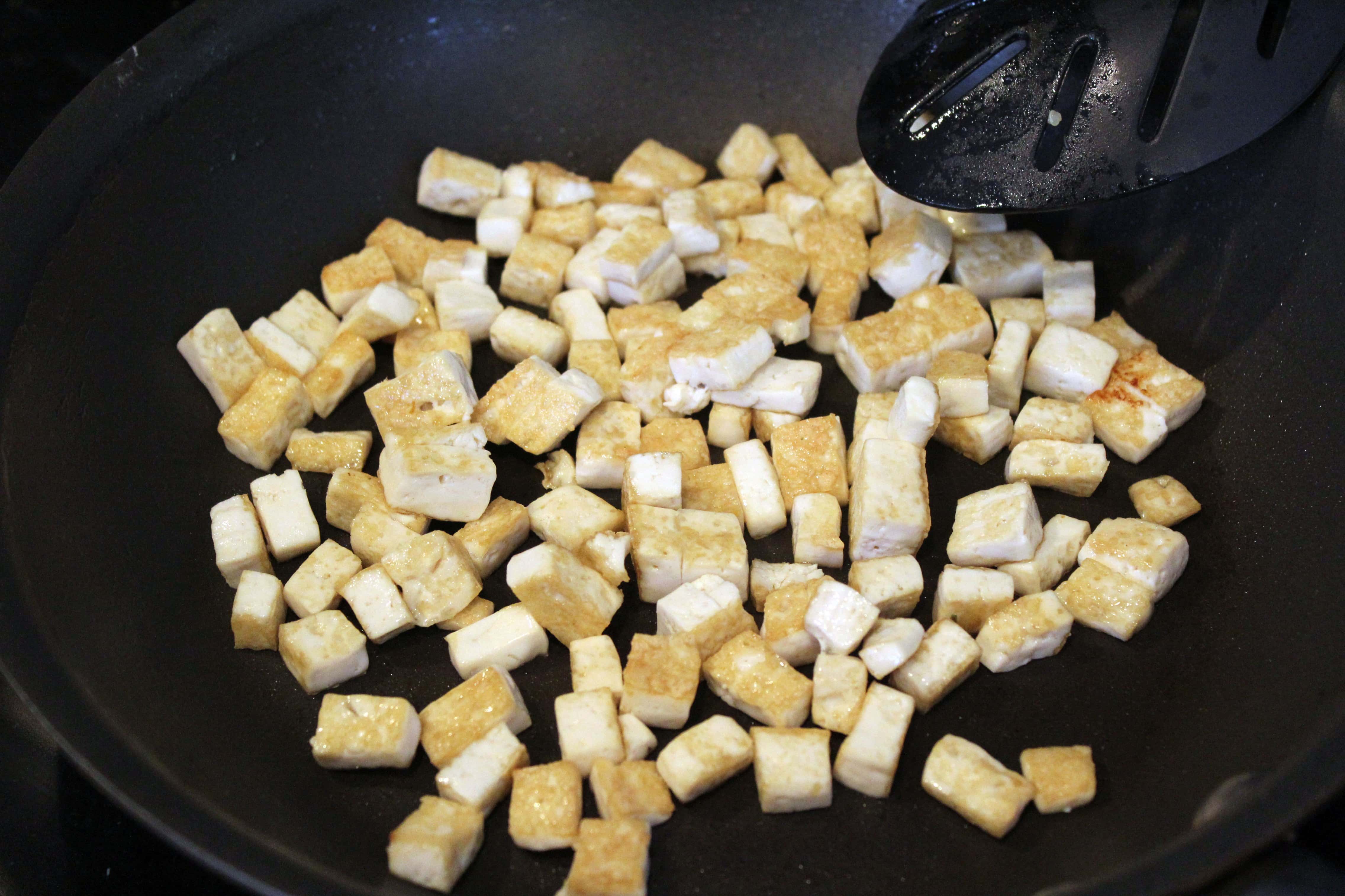 Toss tofu until crispy