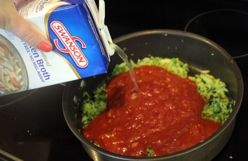 Add marinara and stock to zucchini