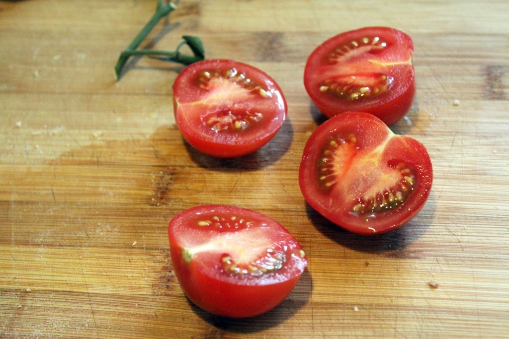 Cut tomatoes in half