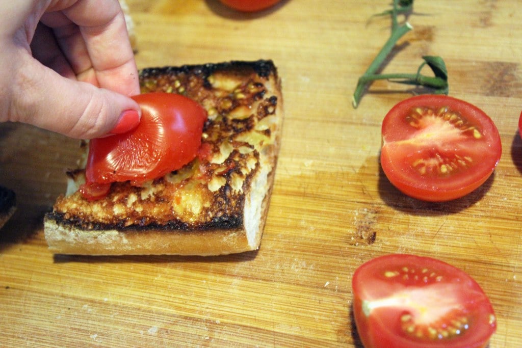 Rub toasted bread with tomato