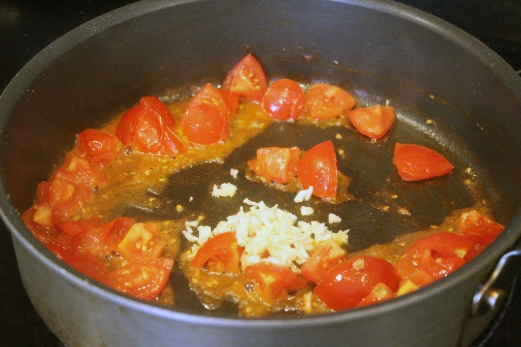 Add garlic to tomatoes