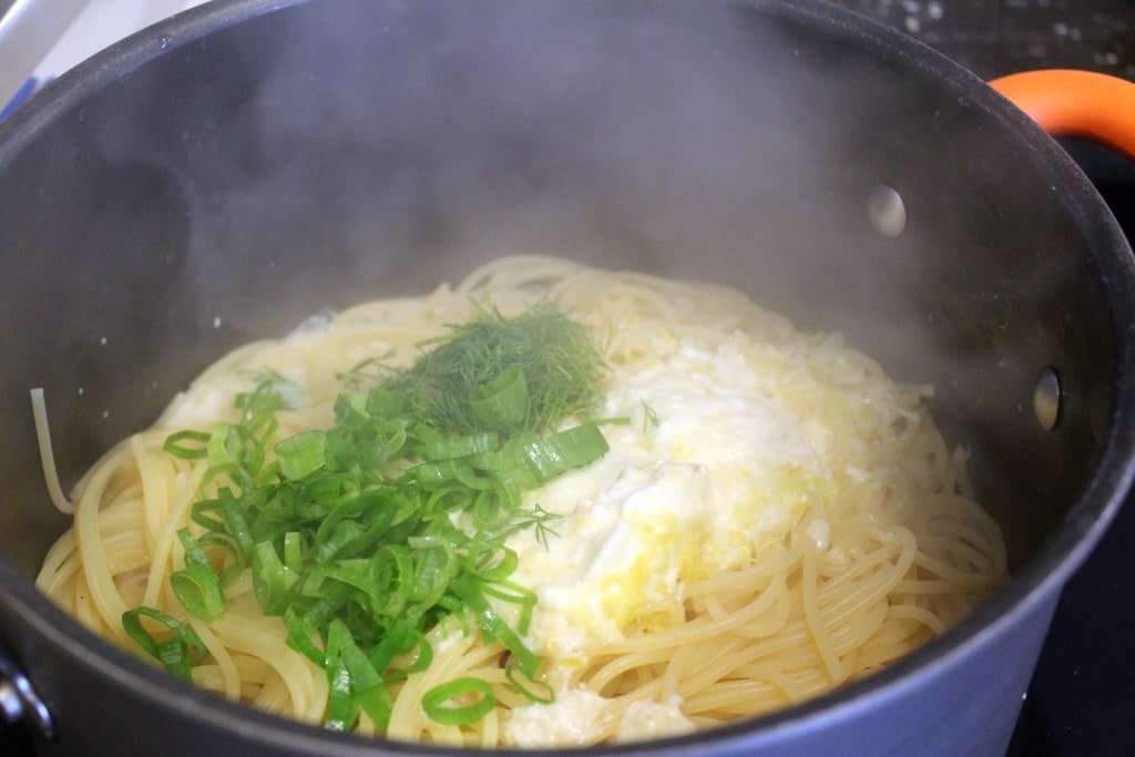 Add herbs with sauce to pasta
