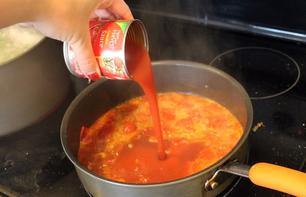 Add tomato sauce to wine mixture