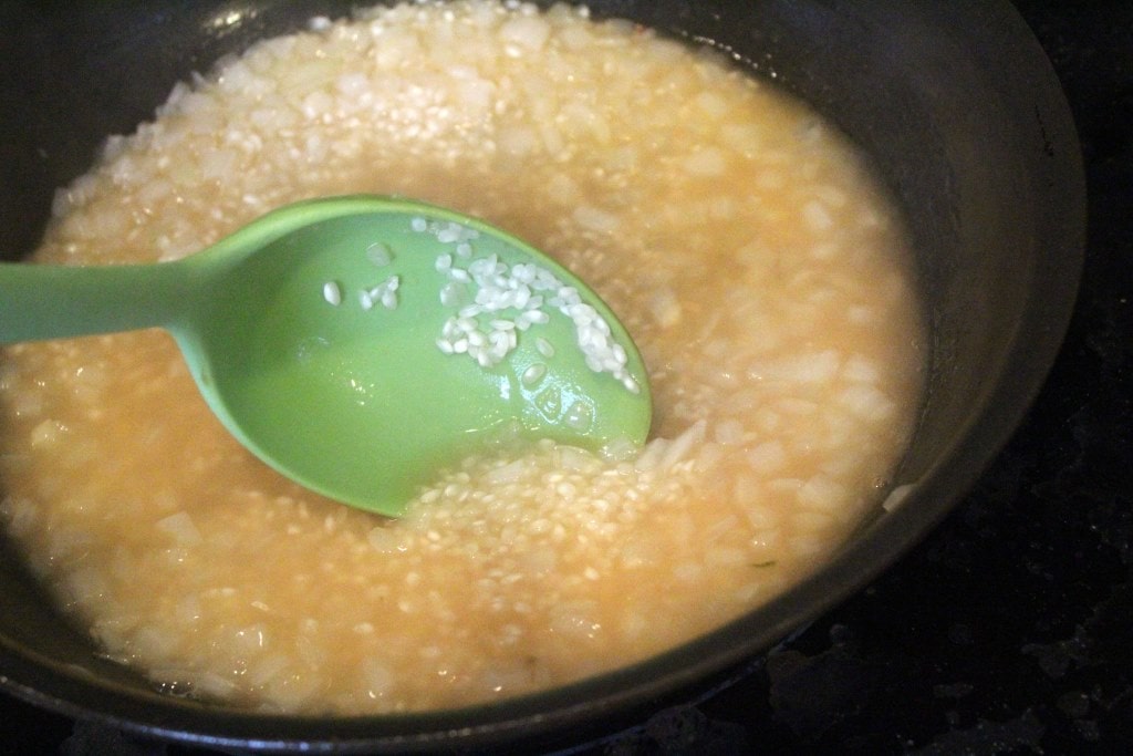 Stir stock into risotto