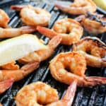 cooked grilled shrimp on grill pan with lemon slices