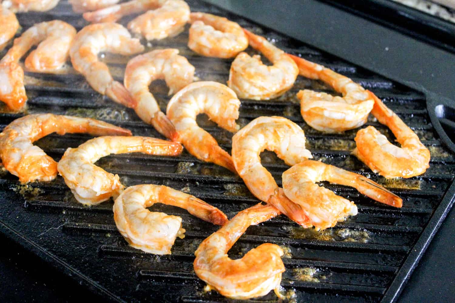 shrimp on grill pan with hot sauce