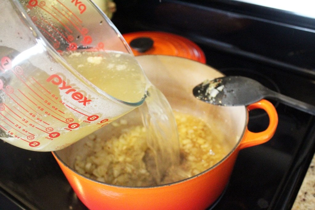Add broth to onion mixture