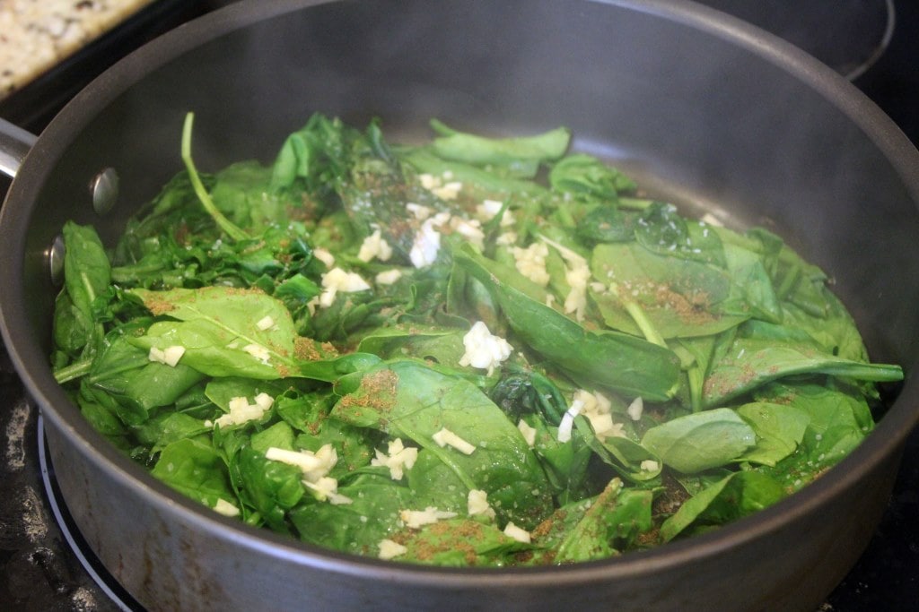 Add seasonings and garlic to spinach