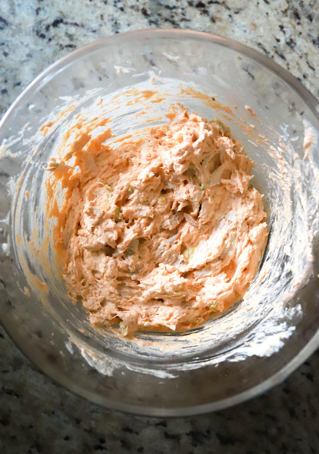 Glass bowl with buffalo chicken dip made with rotisserie chicken.