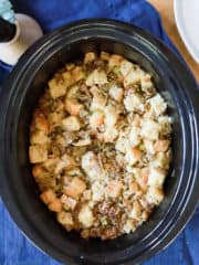 top view of slow cooker sausage stuffing with apples and celery.