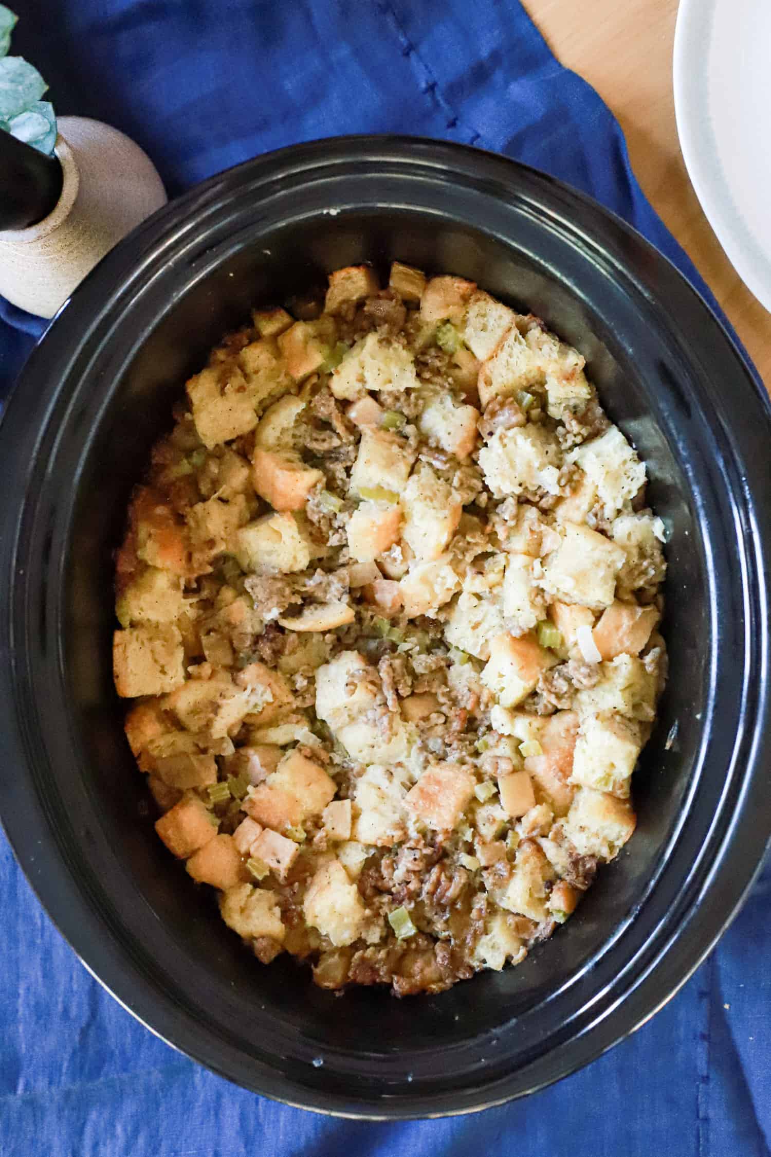 top view of slow cooker sausage stuffing with apples and celery.