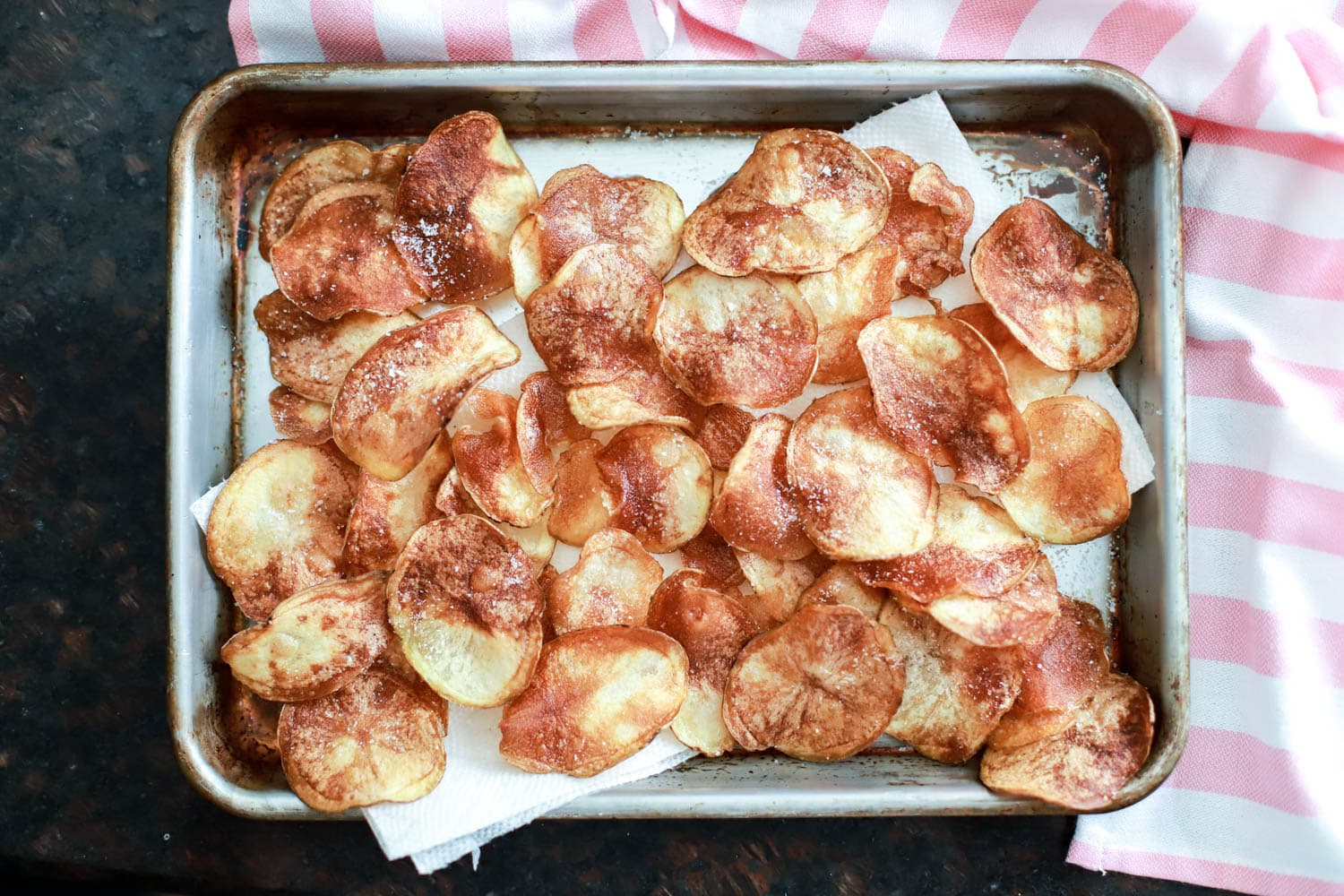 baking sheet of homemade pan fried potato chips.