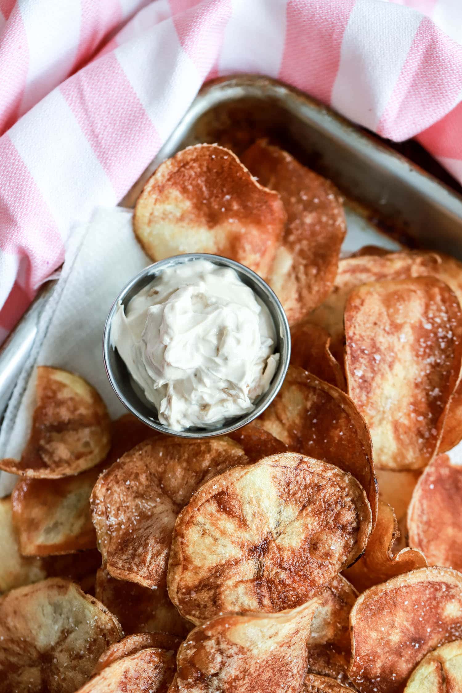 pan fried potato chips close up with small ramekin of onion dip.