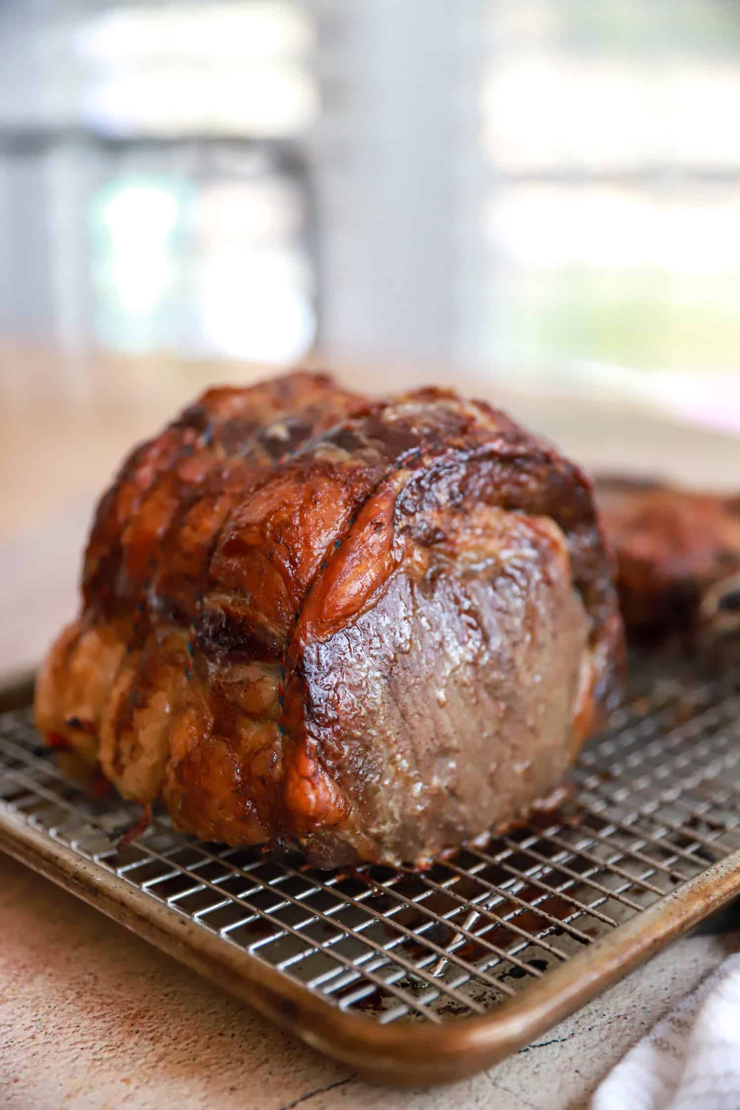 side view of standing rib roast tied in three places.